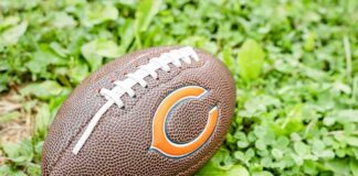 Football on grass with orange C logo