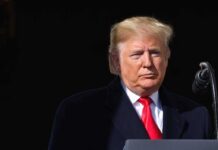 Trump Speech Disrupted by Heated Protest Donald Trump at a podium with a microphone
