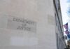 Department of Justice building exterior with American flags
