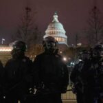 Two Major Disputes Put Washington’s Claims Under Pressure Riot police in protective gear stand before a domed capitol building at night