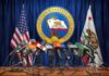 California’s New Laws Take Effect Next Year Press microphones at a podium before California governor seal