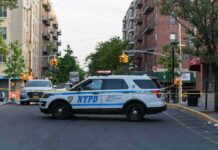 Seven Shots Fired During Bronx Arrest NYPD police SUV blocking a city street at a taped-off scene