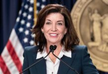 Republican Senator Crosses Party Lines woman speaking at a podium with microphones
