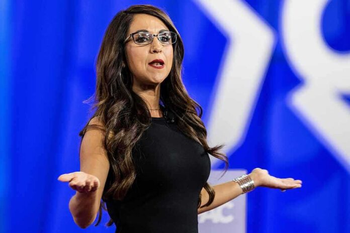Woman speaking on stage with arms outstretched