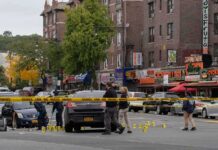 Feds Target Minneapolis Properties in Fraud Case Police investigate a taped-off urban street crime scene