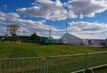 Tragedy at Wichita Youth Soccer Complex Temporary white tents and equipment on a grassy field with traffic cones and metal barriers