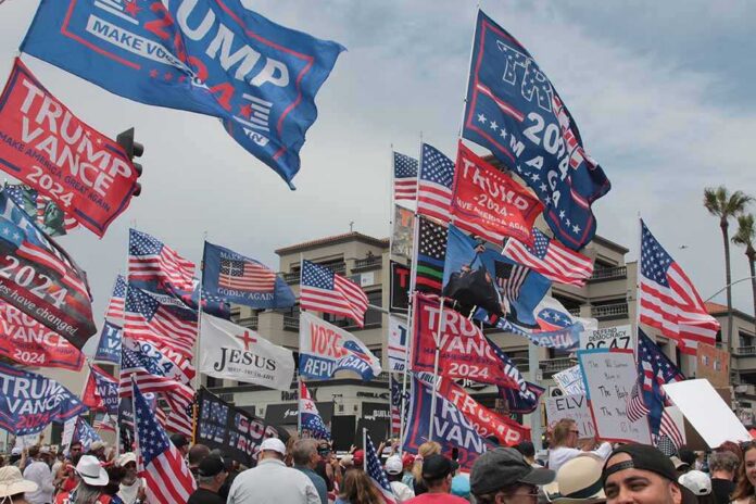 Crowd at political rally with many American and campaign flags