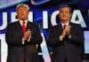 $10M in MAGA Ads Boost Paxton’s Senate Bid two men in suits clapping on a brightly lit stage