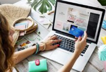 Person shopping online with a credit card at a laptop