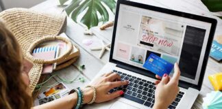 Person shopping online with a credit card at a laptop