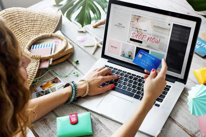 Person shopping online with a credit card at a laptop