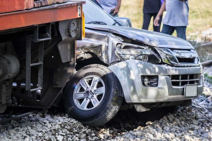 shutterstock_648414016 silver SUV collided with a train at a railway crossing