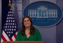 woman speaking at a White House press briefing podium